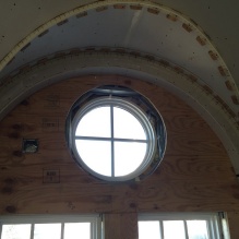 Zoom image: The fourth floor's 17 arched fenestrations and round windows have been restored, serving as a distinctive architectural feature for the school's signature lecture hall and event space. 