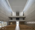 The dramatically high space inside the church is lit from two large hidden clerestory windows that run the whole length of the building, promoting a sense of weightlessness and spirituality within the hardness of the concrete envelope.