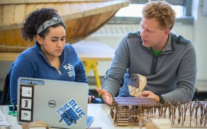 Professor and student discuss an architectural model in studio. 