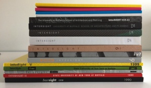 Photograph of previous Intersight editions stacked on top of each other. 