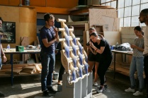 workshop participants from Shop Architects photograph their project, a series of self supporting, interlocked terra cotta pieces. 